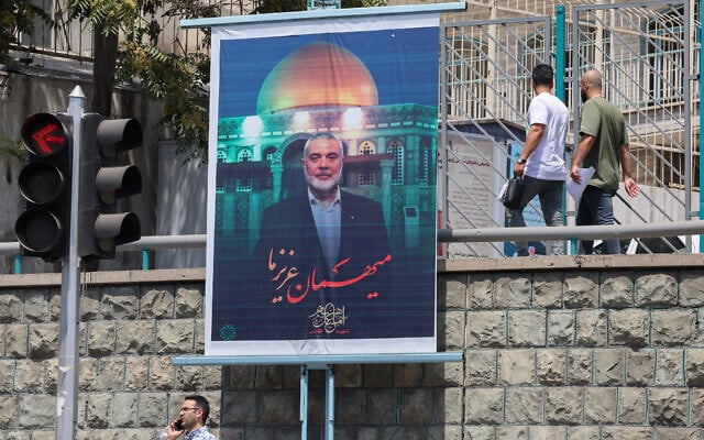 People walk past a poster of slain Palestinian Hamas terror group leader Ismail Haniyeh in Iran's capital Tehran on August 10, 2024. (Atta Kenare/AFP) People walk past a poster of slain Palestinian Hamas terror group leader Ismail Haniyeh in Iran's capital Tehran on August 10, 2024. (Atta Kenare/AFP)