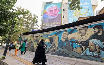 People walk past a billboard showing a portrait of Hamas leader Yahya Sinwar (top) next to Palestine Square in Tehran on August 12, 2024. (Atta Kenare/AFP)
