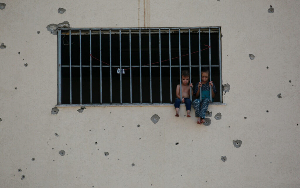 Palestinian children sit on a window sill at the Asdaa central prison facility which has become a shelter for displaced people in Khan Younis in the southern Gaza Strip on August 14, 2024. (Bashar TALEB / AFP)