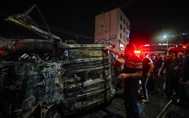 Palestinians and rescuers gather around a car targeted in an Israeli airstrike that killed two senior Hamas operatives in the West Bank city of Jenin on August 17, 2024. (Mohammad Mansour/AFP) Palestinians and rescuers gather around a car targeted in an Israeli airstrike that killed two senior Hamas operatives in the West Bank city of Jenin on August 17, 2024. (Mohammad Mansour/AFP)