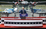 Former US President and Republican presidential candidate Donald Trump speaks behind bulletproof glass during a campaign rally at the North Carolina Aviation Museum & Hall of Fame in Asheboro, North Carolina, August 21, 2024. (Photo by Peter Zay / AFP)