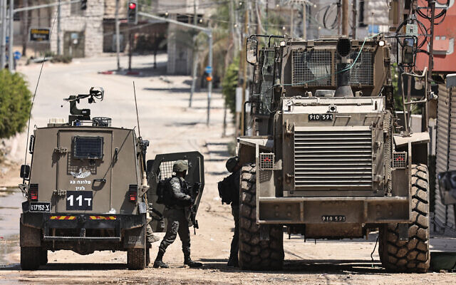 Israeli soldiers and military vehicles deploy in Nur Shams camp near Tulkarem on August 22, 2024. (Zain JAAFAR / AFP) Israeli soldiers and military vehicles deploy in Nur Shams camp near Tulkarem on August 22, 2024. (Zain JAAFAR / AFP)