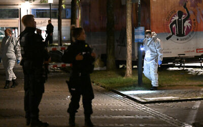 Forensic police use torch lights on August 24, 2024 to inspect the scene where at least three people were killed and several injured when a man attacked them with a knife on late August 23, 2024 in Solingen, western Germany, according to German media, as the city celebrated its 650th anniversary. (Photo by INA FASSBENDER / AFP)