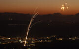Rockets fired by Hezbollah from southern Lebanon are intercepted by the Iron Dome air defense system over the Upper Galilee region in northern Israel on August 23, 2024. (Jalaa Marey/AFP)