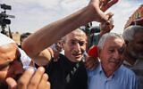 Relatives and friends of rescued hostage Farhan al-Qadi welcome him as he returns to the southern village of Khirbet Karkour, near the Bedouin city of Rahat, August 28, 2024. (Ahmad Gharabli / AFP)