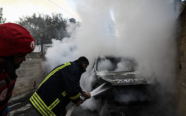 A firefighter extinguishes the flames of a smouldering car in the town of Zababdeh, southeast of Jenin in the West Bank on August 30, 2024, following an Israeli drone strike against Hamas's Jenin military wing commander and two operatives. (Ronaldo Schemidt/AFP) A firefighter extinguishes the flames of a smouldering car in the town of Zababdeh, southeast of Jenin in the West Bank on August 30, 2024, following an Israeli drone strike against Hamas's Jenin military wing commander and two operatives. (Ronaldo Schemidt/AFP)