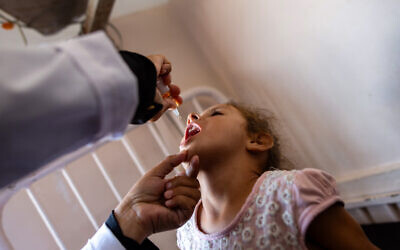 A nurse administers Polio vaccine drops to a girl at the Nasser hospital in Khan Yunis in the southern Gaza Strip on August 31, 2024 (Jihad Al-Sharafi / AFP)