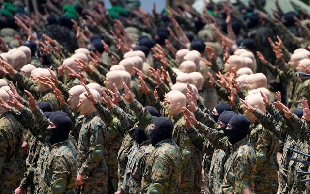 Gunmen from the Lebanese terror group Hezbollah carry out a training exercise in Aaramta village in the Jezzine District, southern Lebanon, May 21, 2023. (AP Photo/Hassan Ammar, File)