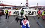 Aysha Abraibesh leads a chant while pro-Palestinian, anti-Israel demonstrators block commute traffic on the Golden Gate Bridge on February 14, 2024, in San Francisco. (AP Photo/Noah Berger)