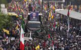 Iranians follow a truck, center, carrying the coffins of Hamas terror group leader Ismail Haniyeh and his bodyguard who were killed in an assassination blamed on Israel, during their funeral ceremony at Enqelab-e-Eslami (Islamic Revolution) Sq. in Tehran, Iran, August 1, 2024. (AP Photo/ Vahid Salemi)
