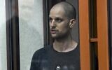 Wall Street Journal reporter Evan Gershkovich stands listening to the verdict in a glass cage of a courtroom inside the building of 'Palace of justice,' in Yekaterinburg, Russia, on July 19, 2024. (AP)