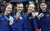 L-R: Erin Gemmel, Katie Ledecky, Paige Madden and Claire Weinstein; The United States' women's 4x200-meter freestyle relay team pose with their silver medals at the 2024 Summer Olympics, Thursday, Aug. 1, 2024, in Nanterre, France. (AP Photo/Matthias Schrader)