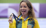 Bronze medalist Jemima Montag, of Australia, stands on the podium after the women's 20km race walk at the 2024 Summer Olympics, Friday, Aug. 2, 2024, in Saint-Denis, France. (AP Photo/Martin Meissner)