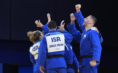 Members of Israel's team celebrate their victory during the mixed team elimination round against Mongolia in the team judo competition, at Champ-de-Mars Arena, during the 2024 Summer Olympics, Aug. 3, 2024, in Paris, France. (AP/Eugene Hoshiko)