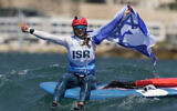 Sharon Kantor of Israel celebrates her women's iQFOiL windsurfing class silver medal win among the waves during the 2024 Summer Olympics, August 3, 2024, in Marseille, France. (AP Photo/Carolyn Kaster)