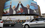 Vehicles drive past a huge banner showing the Hamas terror group leader Ismail Haniyeh, left, who was killed in an assassination last week, joining hands with Iranian President Masoud Pezeshkian, in a square in downtown Tehran, Iran, Aug. 5, 2024. (AP/Vahid Salemi)