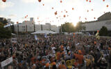 Family, friends and supporters of Ariel Bibas, who is held hostage by Hamas in the Gaza Strip, release orange balloons to mark his fifth birthday in Tel Aviv, August 5, 2024. (AP Photo/ Mahmoud Illean)