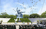 Doves fly over the Peace Statue during a ceremony to mark the 79th anniversary of the US atomic bombing at the Peace Park in Nagasaki, southern Japan Friday, Aug. 9, 2024. (Japan Pool/Kyodo News via AP)