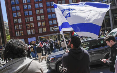 New York University students and pro-Israeli supporters rally across from where pro-Palestinian students and supporters are protesting outside the NYU Stern School of Business building, April 22, 2024, in New York. (AP/Mary Altaffer)