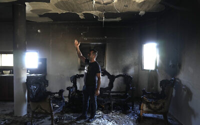 People check the damage inside their home, a day after an attack by Jewish settlers on the village of Jit near Nablus in the West Bank that left a 23-year-old man dead and others with critical gunshot wounds, on August 16, 2024 (AP Photo/Nasser Nasser)