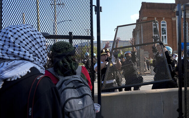 Police replace a piece of fence knocked down by pro-Palestinian, anti-Israel protesters surrounding the United Center at the Democratic National Convention after a march, August 19, 2024, in Chicago. (AP Photo/Frank Franklin II) Police replace a piece of fence knocked down by pro-Palestinian, anti-Israel protesters surrounding the United Center at the Democratic National Convention after a march, August 19, 2024, in Chicago. (AP Photo/Frank Franklin II)