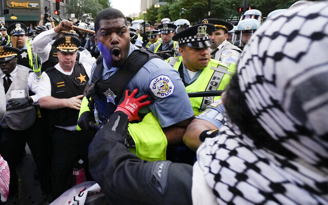 Pro-Palestinian demonstrators clash with police near the Israeli consulate during the Democratic National Convention, August 20, 2024, in Chicago. (AP Photo/Julio Cortez)