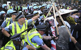 Pro-Palestinian demonstrators clash with police near the Israeli consulate during the Democratic National Convention, on August 20, 2024, in Chicago. (AP Photo/Noah Berger)