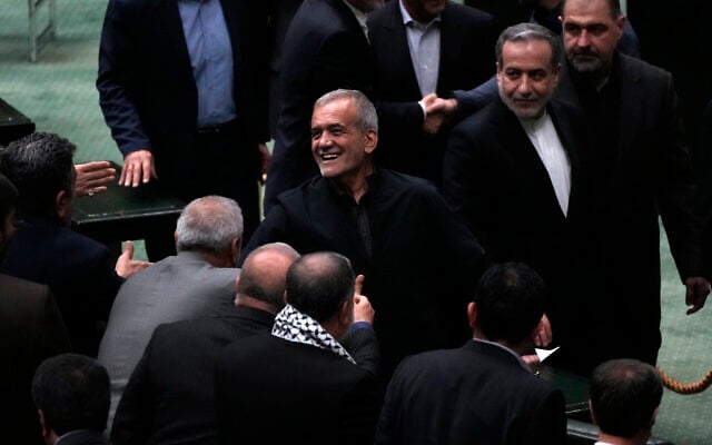Iranian President Masoud Pezeshkian, center, is greeted by lawmakers while leaving the parliament after his speech during the debate on his proposed ministers, at the Majlis in Tehran, August 21, 2024. (AP Photo/Vahid Salemi) Iranian President Masoud Pezeshkian, center, is greeted by lawmakers while leaving the parliament after his speech during the debate on his proposed ministers, at the Majlis in Tehran, August 21, 2024. (AP Photo/Vahid Salemi)