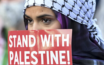 A protester listens during a demonstration near the Democratic National Convention in Chicago, Illinois, August 22, 2024. (AP/Noah Berger) A protester listens during a demonstration near the Democratic National Convention in Chicago, Illinois, August 22, 2024. (AP/Noah Berger)