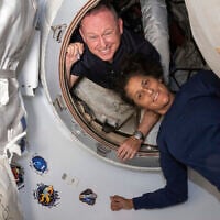 Astronauts Butch Wilmore, left, and Suni Williams pose inside the vestibule between the International Space Station's Harmony module and Boeing's Starliner spacecraft on June 13, 2024. (NASA via AP)