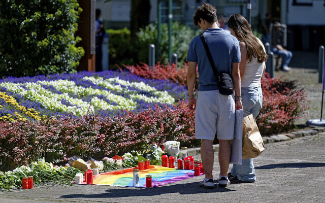 People lay flowers near the scene of a knife attack in Solingen city center, Germany, Saturday August 24, 2024, after three people were killed and at least eight people were wounded Friday night at the festival. (Henning Kaiser/dpa via AP) People lay flowers near the scene of a knife attack in Solingen city center, Germany, Saturday August 24, 2024, after three people were killed and at least eight people were wounded Friday night at the festival. (Henning Kaiser/dpa via AP)