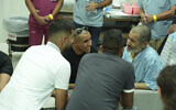 In this photo released by the Prime Minister's Office on Aug. 27, 2024, Farhan al-Qadi, 52, right meets relatives at the Soroka Medical Center in Beersheba, Israel. (Yossi Ifergan/GPO)