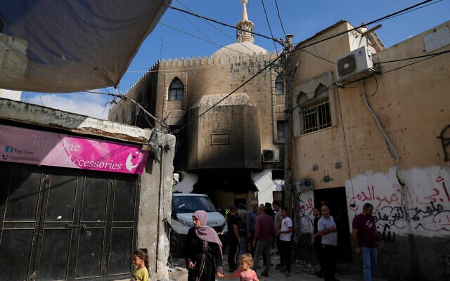 Palestinians stand outside a damaged mosque following an Israeli military operation in the West Bank refugee camp of Al-Faraa, Thursday, Aug. 29, 2024. (AP Photo/Nasser Nasser) Palestinians stand outside a damaged mosque following an Israeli military operation in the West Bank refugee camp of Al-Faraa, Thursday, Aug. 29, 2024. (AP Photo/Nasser Nasser)