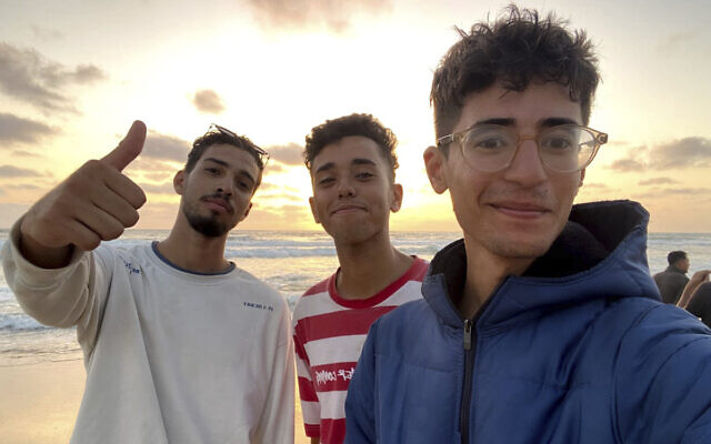 In this undated photo provided by Helmi Hirez, Mohamed (Medo) Halimy, left, and twin brothers Mohammed Hirez, center, and Helmi Hirez, right, stand on a beach in Gaza. (Helmi Hirez via AP) In this undated photo provided by Helmi Hirez, Mohamed (Medo) Halimy, left, and twin brothers Mohammed Hirez, center, and Helmi Hirez, right, stand on a beach in Gaza. (Helmi Hirez via AP)