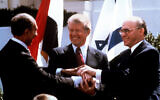 Then-Prime Minister Menachem Begin, right, US President Jimmy Carter, center, and Egyptian President Anwar Sadat, left, clasp hands on the North Lawn of the White House as they completed signing of the peace treaty between Egypt and Israel in Washington, March 26, 1979. (AP Photo/Bob Daugherty)