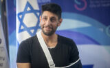Singer-songwriter and reservist Idan Amedi attends a press conference following his release from Sheba Medical Center, in central Israel, after being seriously injured in the Gaza Strip, January 25, 2024. (Miriam Alster/ Flash90)