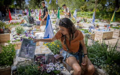 Illustrative: Friends and family members mourn near graves of Israeli soldiers killed on October 7, at Mount Herzl Military Cemetery in Jerusalem, on May 9, 2024. (Chaim Goldberg/Flash90)
