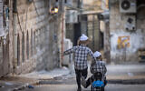 Ultra-Orthodox children play in the Haredi neighborhood of Mea Shearim, Jerusalem, on June 26, 2024. (Chaim Goldberg/Flash90)