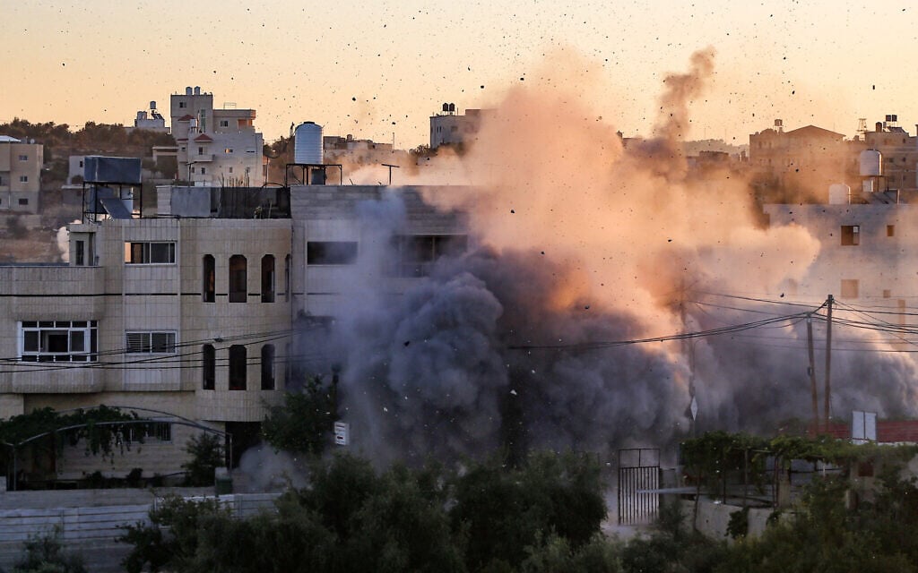 The home of a Palestinian who carried out a terror attack in Gan Yavne is blown up by Israeli security forces, in the West Bank town of Dura, August 8, 2024. (Wisam Hashlamoun/Flash90)