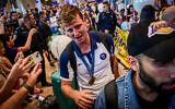 Gold medalist Tom Reuveny and other members of Team Israel arrive home from the 2024 Paris Olympics, at Ben Gurion Airport on August 12, 2024 (Avshalom Sassoni/Flash90)