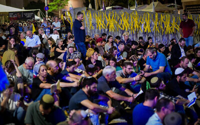 Families and supporters of Israelis held hostage by Hamas in the Gaza Strip gather to mark the Tisha B'Av fast day at Hostages Square in Tel Aviv, August 12, 2024. (Avshalom Sassoni/Flash90)