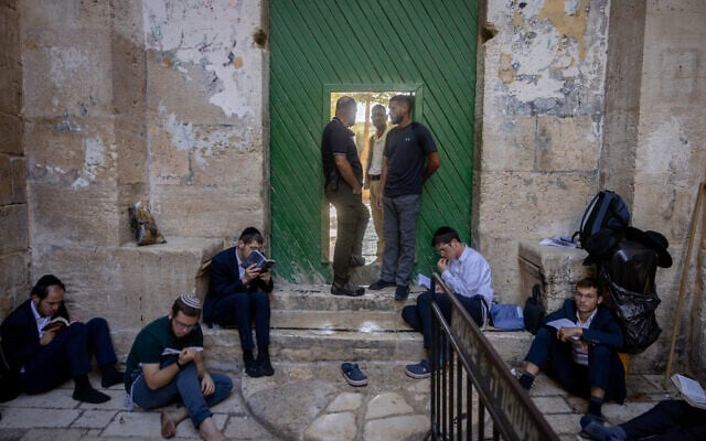Jewish men pray in the Old City of Jerusalem, next to one of the gates to the Temple Mount, during Tisha B'Av, August 13, 2024. (Chaim Goldberg/Flash90) Jewish men pray in the Old City of Jerusalem, next to one of the gates to the Temple Mount, during Tisha B'Av, August 13, 2024. (Chaim Goldberg/Flash90)
