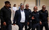 National Security Minister Itamar Ben Gvir with senior police officers at the Western Wall in Jerusalem's Old City, after his visit to the Temple Mount, during Tisha B'Av, August 13, 2024. (Chaim Goldberg/Flash90)