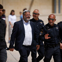 National Security Minister Itamar Ben Gvir with senior police officers at the Western Wall in Jerusalem's Old City, after his visit to the Temple Mount, during Tisha B'Av, August 13, 2024. (Chaim Goldberg/Flash90)