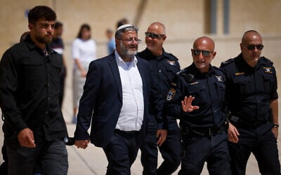 National Security Minister Itamar Ben Gvir with senior police officers at the Western Wall in Jerusalem's Old City, after his visit to the Temple Mount, during Tisha B'Av, August 13, 2024. (Chaim Goldberg/Flash90)