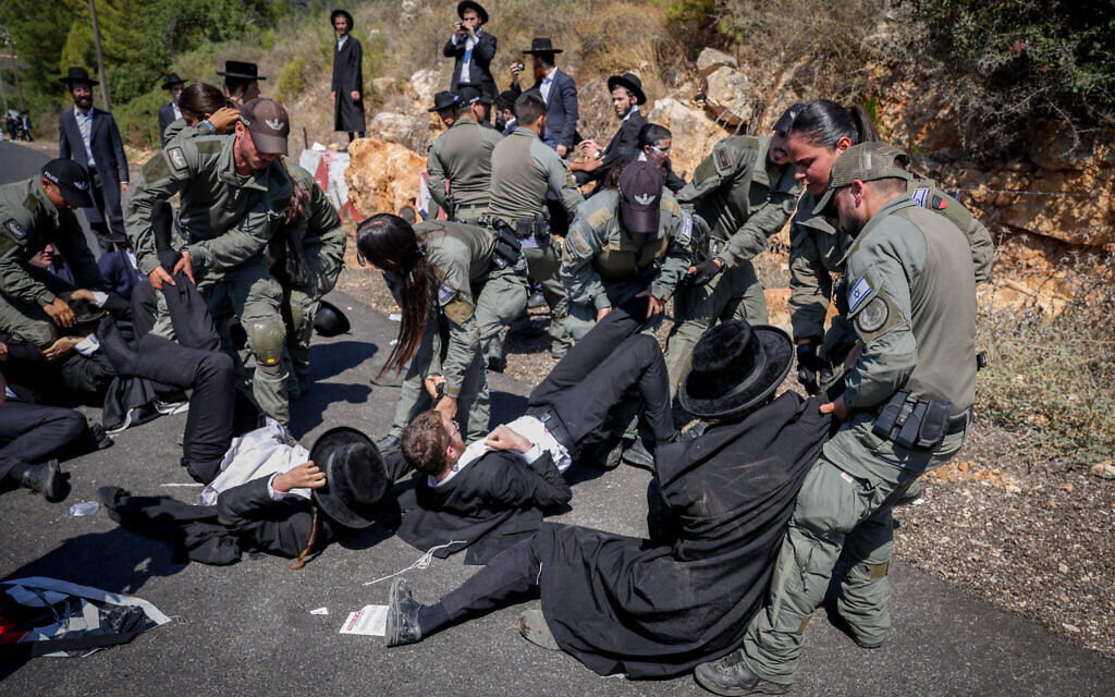 Ultra-Orthodox Jews clash with police during a protest against the drafting of Haredi yeshiva students to the IDF, outside the Mihve Alon military base, in northern Israel, August 14, 2024. (David Cohen/Flash90)