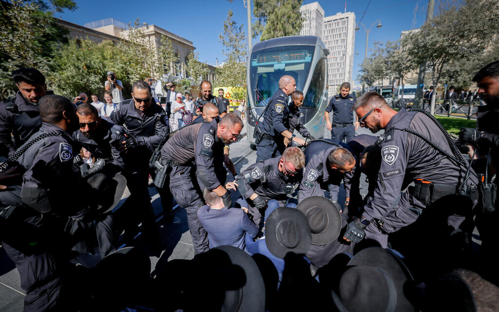 Ultra-Orthodox extremists protest against the drafting of Haredi men to the army, outside an IDF recruitment center in Jeursalem, August 21, 2024. (Chaim Goldberg/Flash90)