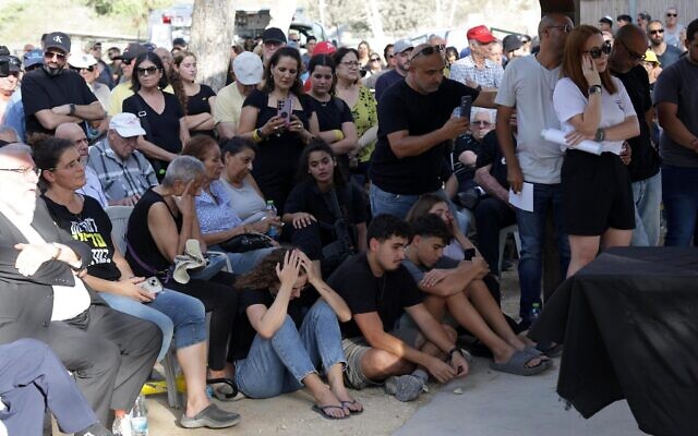 Family and friends attend the funeral service of slain Hamas hostage Yoram Metzger at the cemetery in Kibbutz Nir Oz, on August 22, 2024. (Flash90) Family and friends attend the funeral service of slain Hamas hostage Yoram Metzger at the cemetery in Kibbutz Nir Oz, on August 22, 2024. (Flash90)