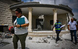 People at the site of a damaged house following a missile attack from Lebanon, in Moshav Manot, northern Israel, August 25, 2024. (Flash90)