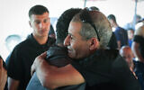 Released hostage Farhan al-Qadi, right, hugs a well-wisher as he arrives his home in the Bedouin village of Khirbet Karkur, near Rahat, southern Israel, August 28, 2024. (Jamal Awad/Flash90)